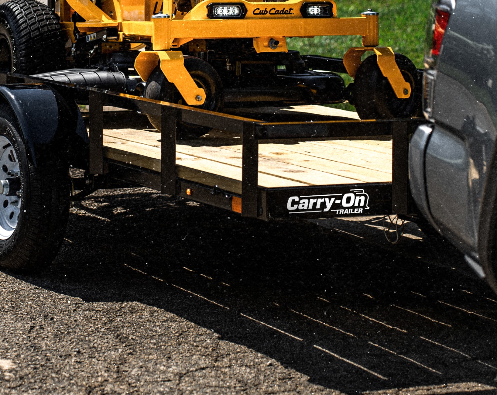 A zero turn lawn mower on a trailer.